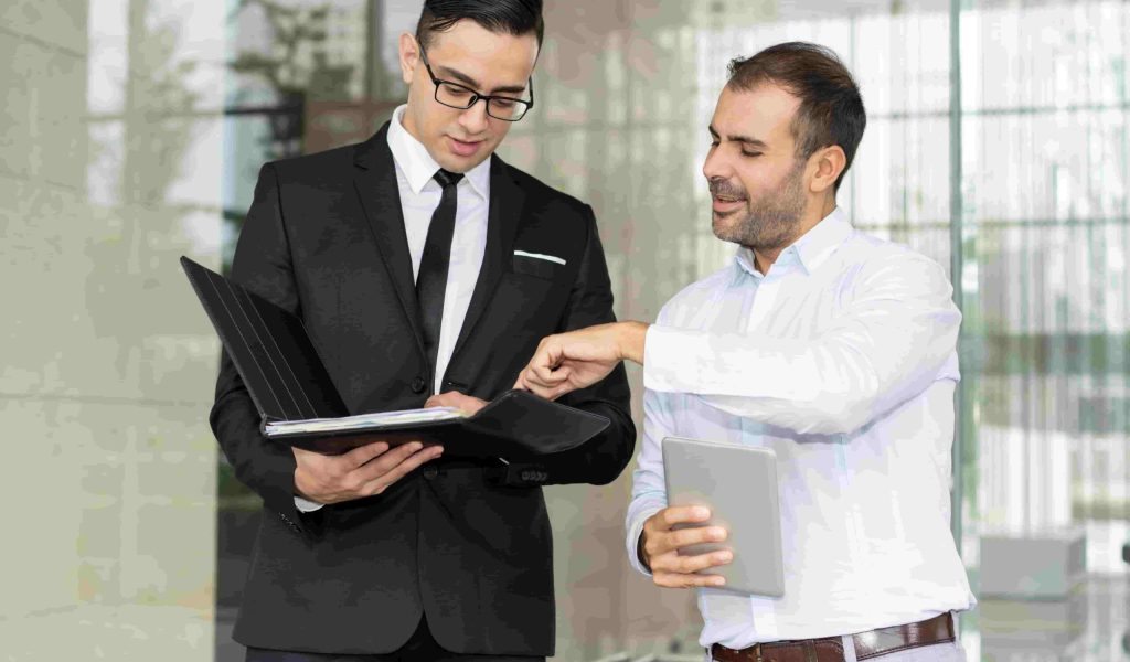 smiling-entrepreneurs-discussing-business-document-folder (1)